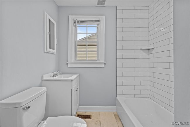 Full bathroom with baseboards, visible vents, toilet, and vanity | Image 10
