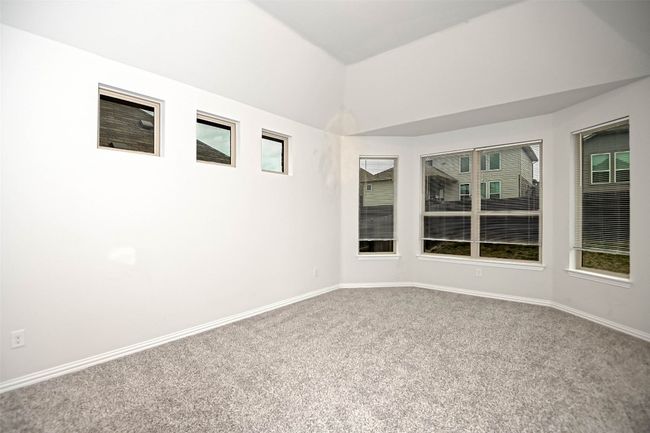 Carpeted spare room with baseboards and vaulted ceiling | Image 16