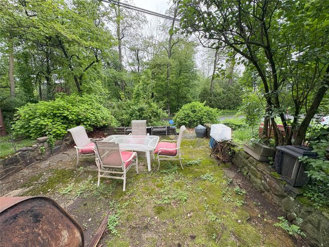 View of yard featuring outdoor dining space and a patio area | Image 12
