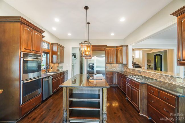 Unleash your inner chef in the stunning kitchen, a culinary oasis w/ ss appliances, granite, center island, walk-in pantry, & butler pantry | Image 12