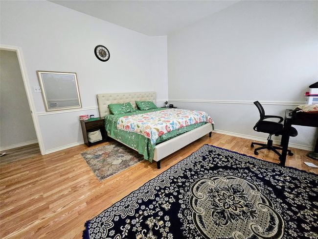 Bedroom featuring wood finished floors and baseboards | Image 20