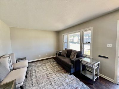 Living room with a textured ceiling and dark hardwood / wood-style floors | Image 2