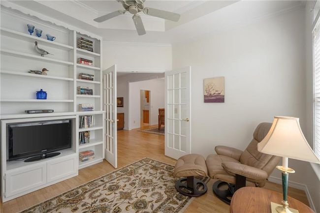 Sitting room with crown molding, french doors, ceiling fan, and light wood-style floors | Image 34