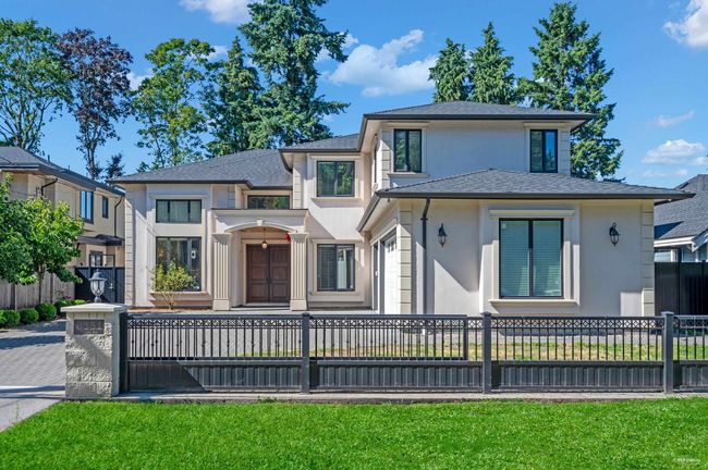 View of front facade featuring stucco siding, a fenced front yard, and a shingled roof | Image 35