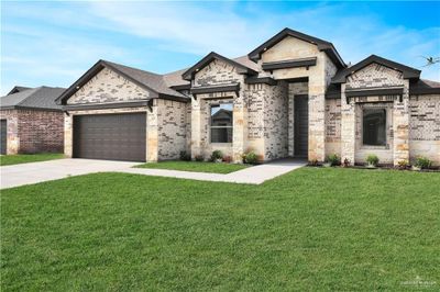 View of front facade with a front yard and a garage | Image 2