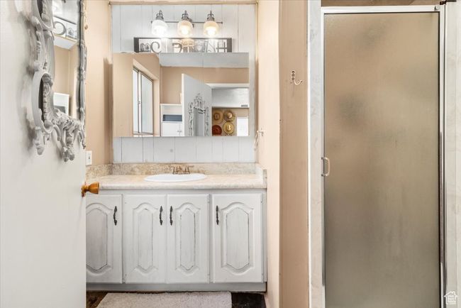 Bathroom featuring a shower stall and vanity | Image 33