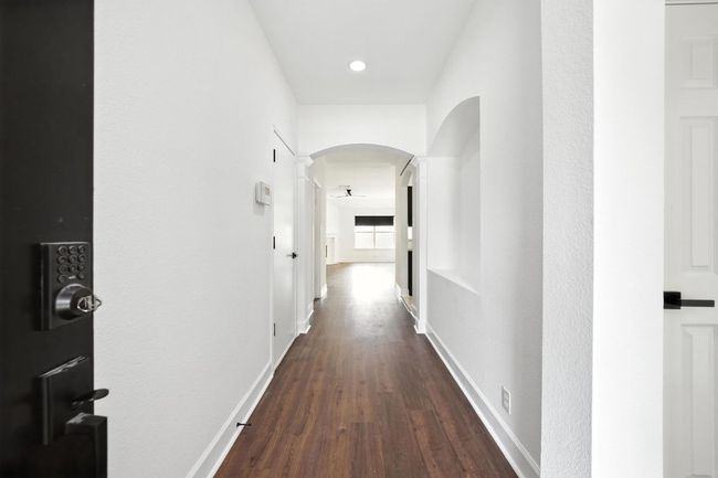 Entry foyer hall featuring wood-style flooring, art niche, and arched walkways | Image 25