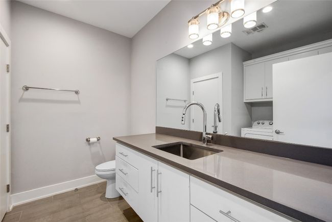 Downstairs half bath and laundry room | Image 11