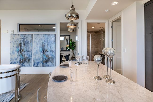 The kitchen island is conveniently located near one of the two bedrooms, offering easy access and functionality. | Image 9