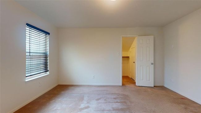 Spacious guest bedroom with natural light and a convenient closet. | Image 32