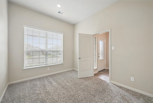 Unfurnished bedroom featuring carpet, visible vents, and baseboards | Image 11