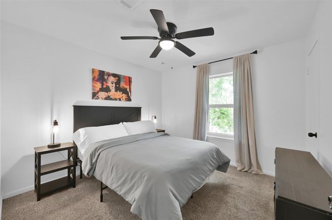 The third Secondary Bedroom overlooks the Front Yard, has a ceiling fan with light and a light plaster treatment applied to the walls adding a decorative touch. | Image 22