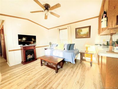 Sunlit living room with propane fireplace. | Image 3