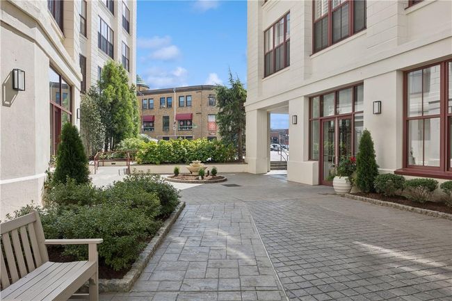 View of the lobby courtyard area. The entire facade has been refinished and landscaping has been updated. | Image 23