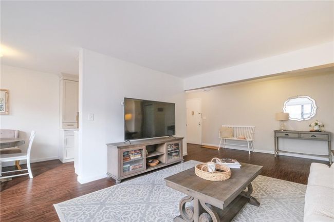 Alternative view of the living room showing flow to dining area. | Image 9