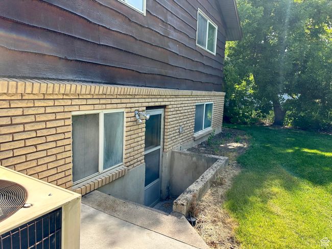 Back view of home and basement yard entrance from patio | Image 23