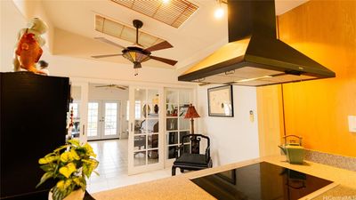 happy chef looking out to family room and patio and swing chair | Image 1