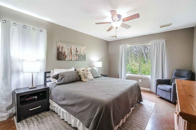 Bedroom featuring baseboards, a ceiling fan, and visible vents | Image 9