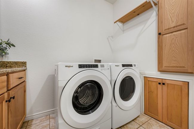 Washer/Dryer convey built in ironing board and built in laundry shoot from primary bedroom. | Image 24