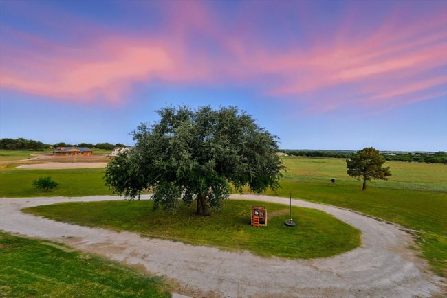 Surrounding community with curved driveway and a yard | Image 39