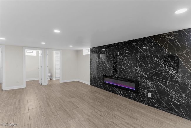 Unfurnished living room featuring recessed lighting and a glass covered fireplace | Image 34