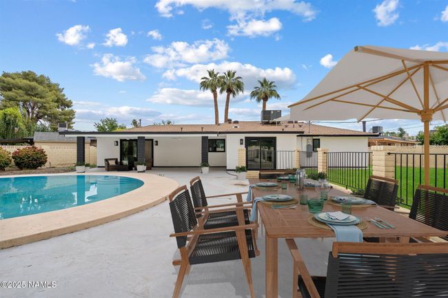 Enjoy outdoor entertaining on your large poolside patio. | Image 38