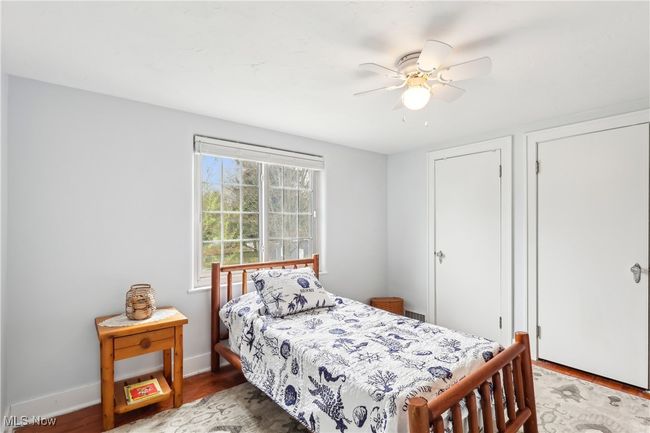 Bedroom featuring wood finished floors, baseboards, and ceiling fan | Image 19