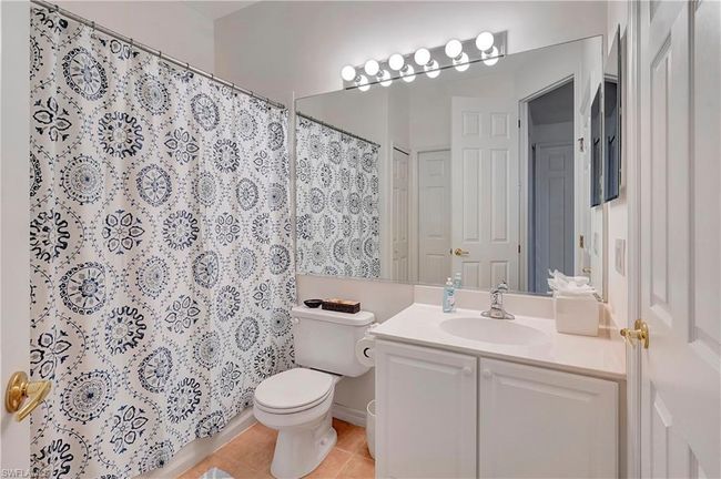Guest Bathroom with walk in shower, tile patterned flooring, vanity, and toilet | Image 19