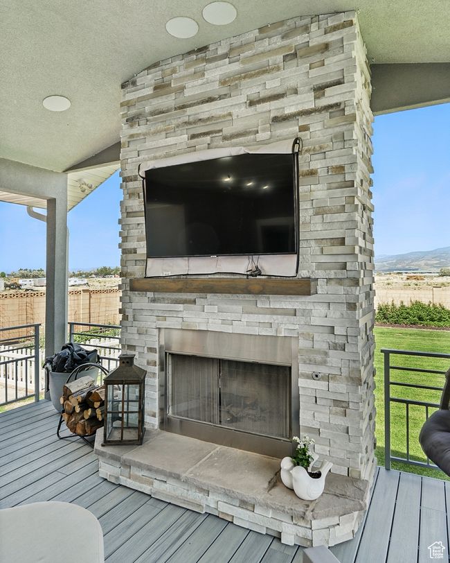 Wooden deck with an outdoor stone fireplace | Image 18