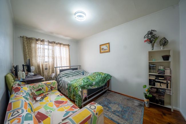 Bedroom featuring wood finished floors, baseboards, and crown molding | Image 19
