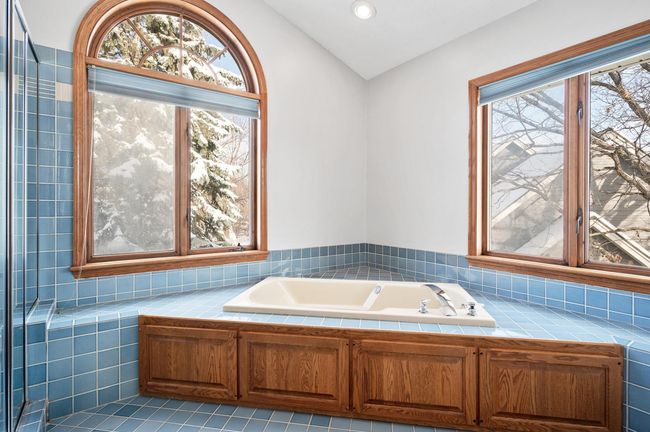 Enjoy the relaxing jetted tub in the owner's private bathroom. The windows flood the room with natural light. | Image 21