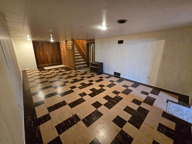 Basement family room with tile flooring | Image 23