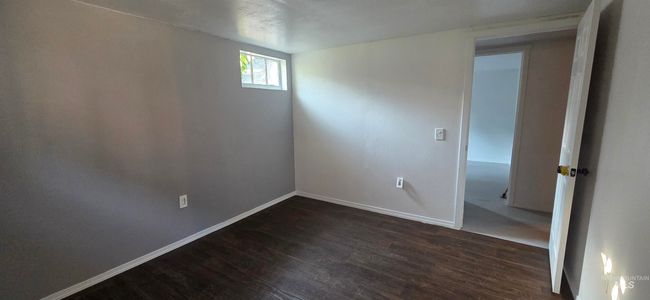Unfurnished room featuring dark wood finished floors and baseboards | Image 17