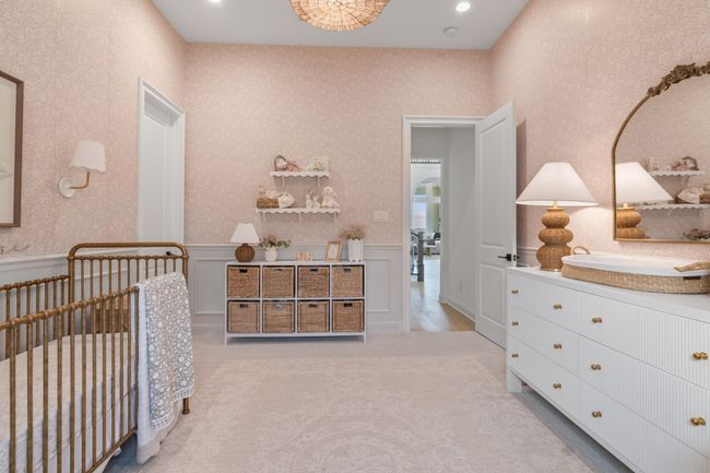 Bedroom featuring a nursery area, a decorative wall, recessed lighting, light carpet, and a wainscoted wall | Image 29