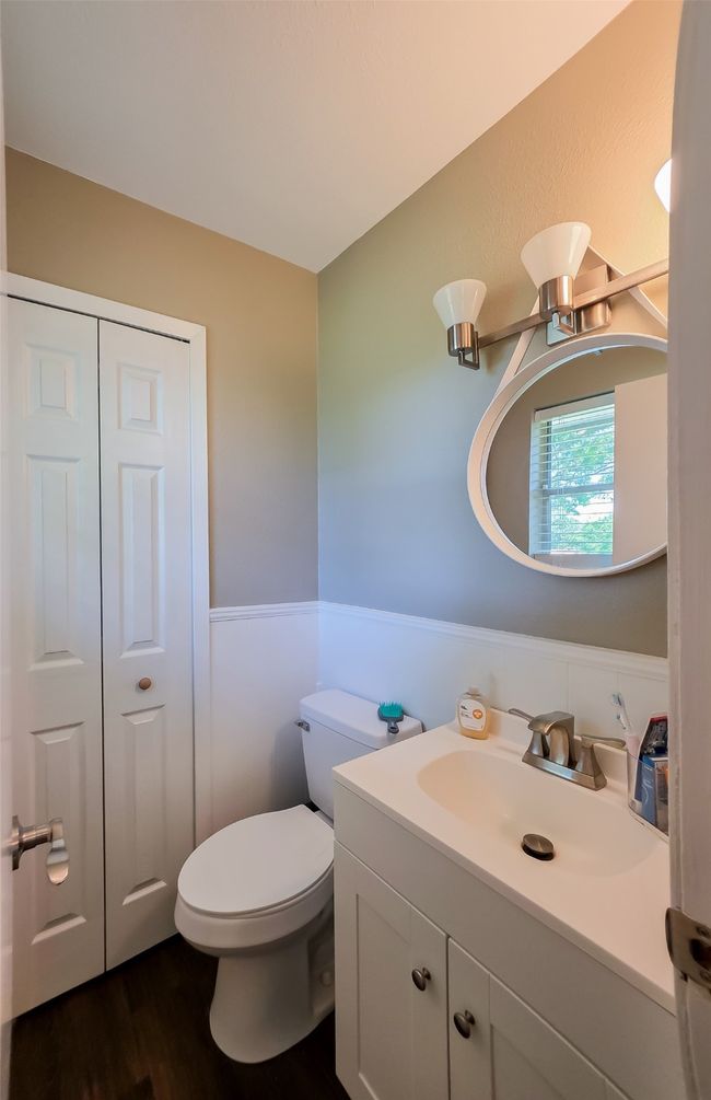 Bathroom with wainscoting, vanity, wood finished floors, and toilet | Image 14