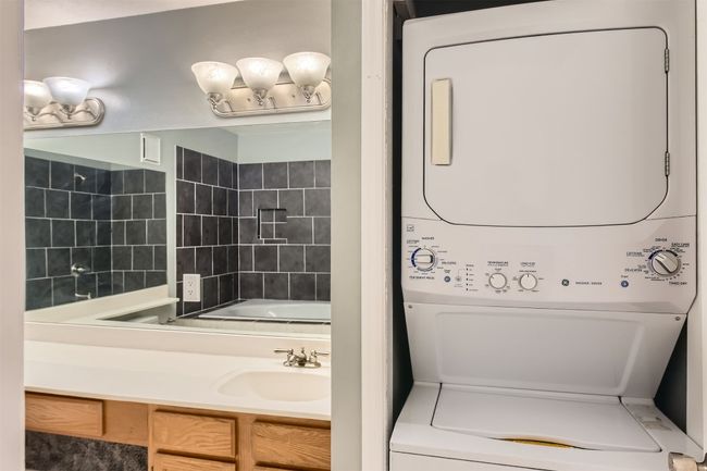 Full bath featuring stacked washer and clothes dryer. | Image 13