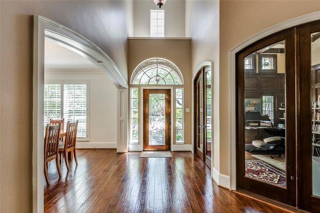 This home has fabulous natural light, enter through a gorgeous lead glass door in to a double height entry. A wonderful executive office with glass doors to the right of the picture, hardwood floors | Image 5