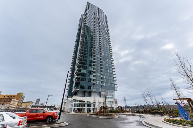 View of building exterior with a view of city and uncovered parking | Image 22