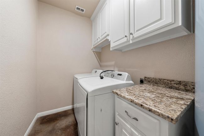 Washroom with cabinet space and washing machine and dryer | Image 9