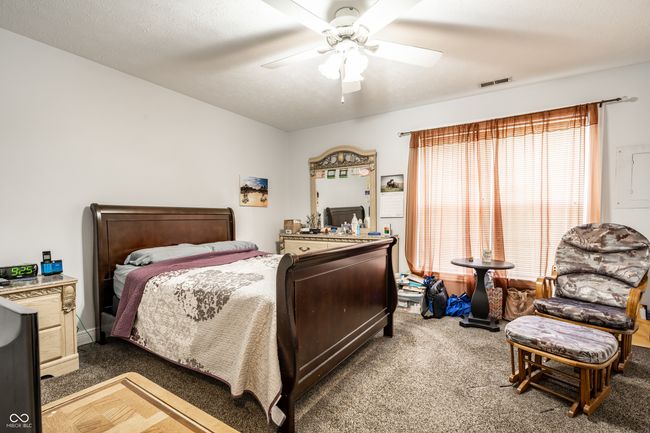 primary bedroom featuring a ceiling fan and double closets | Image 15