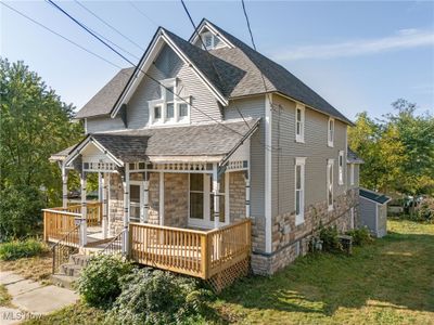 Back of property with a lawn and a deck | Image 2