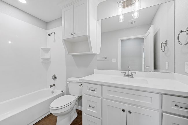 Full bathroom featuring vanity, toilet, visible vents, baseboards, and shower / washtub combination | Image 8