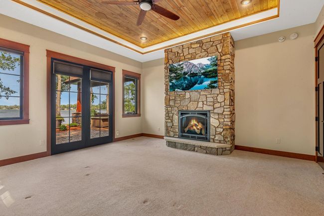 Spacious primary bedroom featuring a cozy gas fireplace, creating a warm and inviting retreat. | Image 47