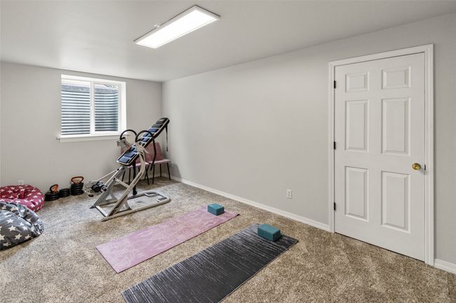 Workout room featuring carpet flooring and baseboards | Image 40