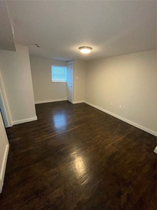 Spare room with baseboards and dark wood-style floors | Image 16