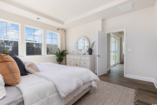 Bedroom featuring dark wood finished floors, baseboards, and a raised ceiling | Image 21