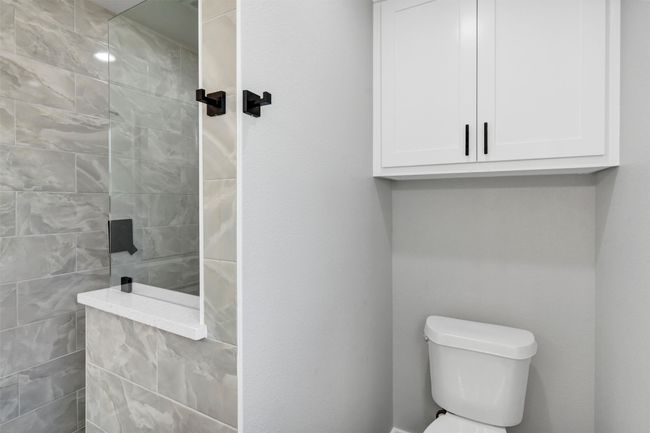 Full bathroom featuring walk in shower and toilet | Image 28