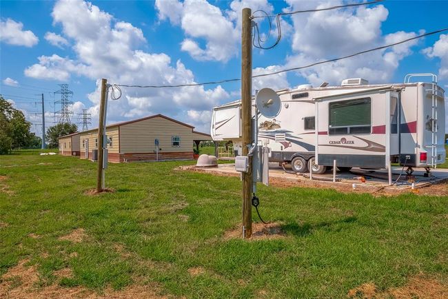 From this angle, the synergy between structures is clear—main house, secondary house, and RV area nestle together in the vast, open acreage, illustrating how the land supports both connection and separation. | Image 35
