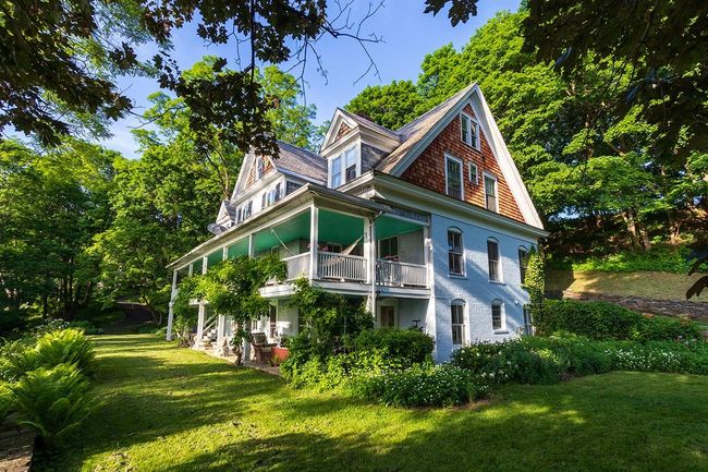 View of property exterior with a balcony and a yard | Image 18
