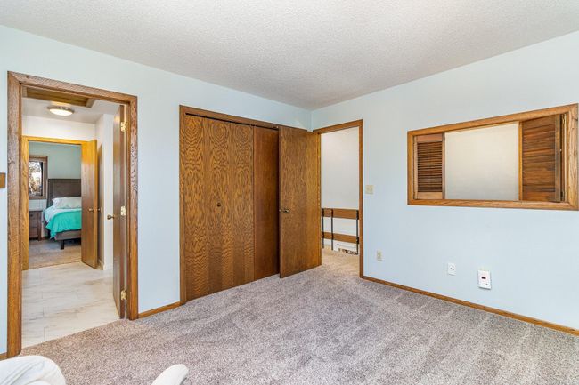 This view of the second bedroom shows the large closet and access to the full bathroom. | Image 27